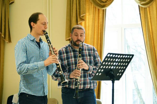 Two men playing the clarinet