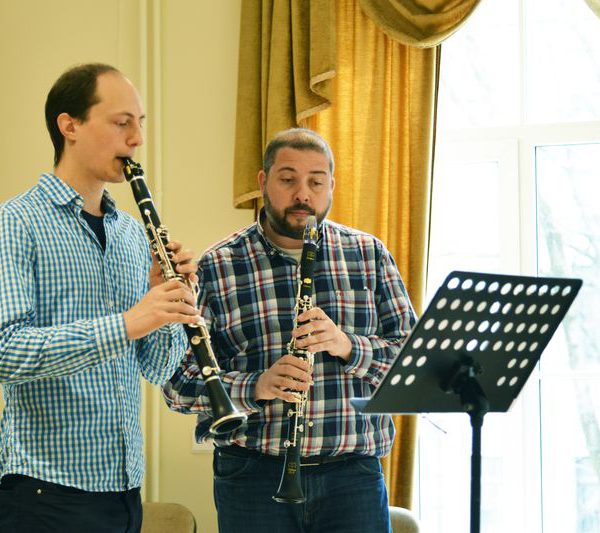 Two men playing the clarinet