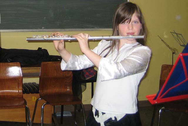 girl in classroom learns transverse flute